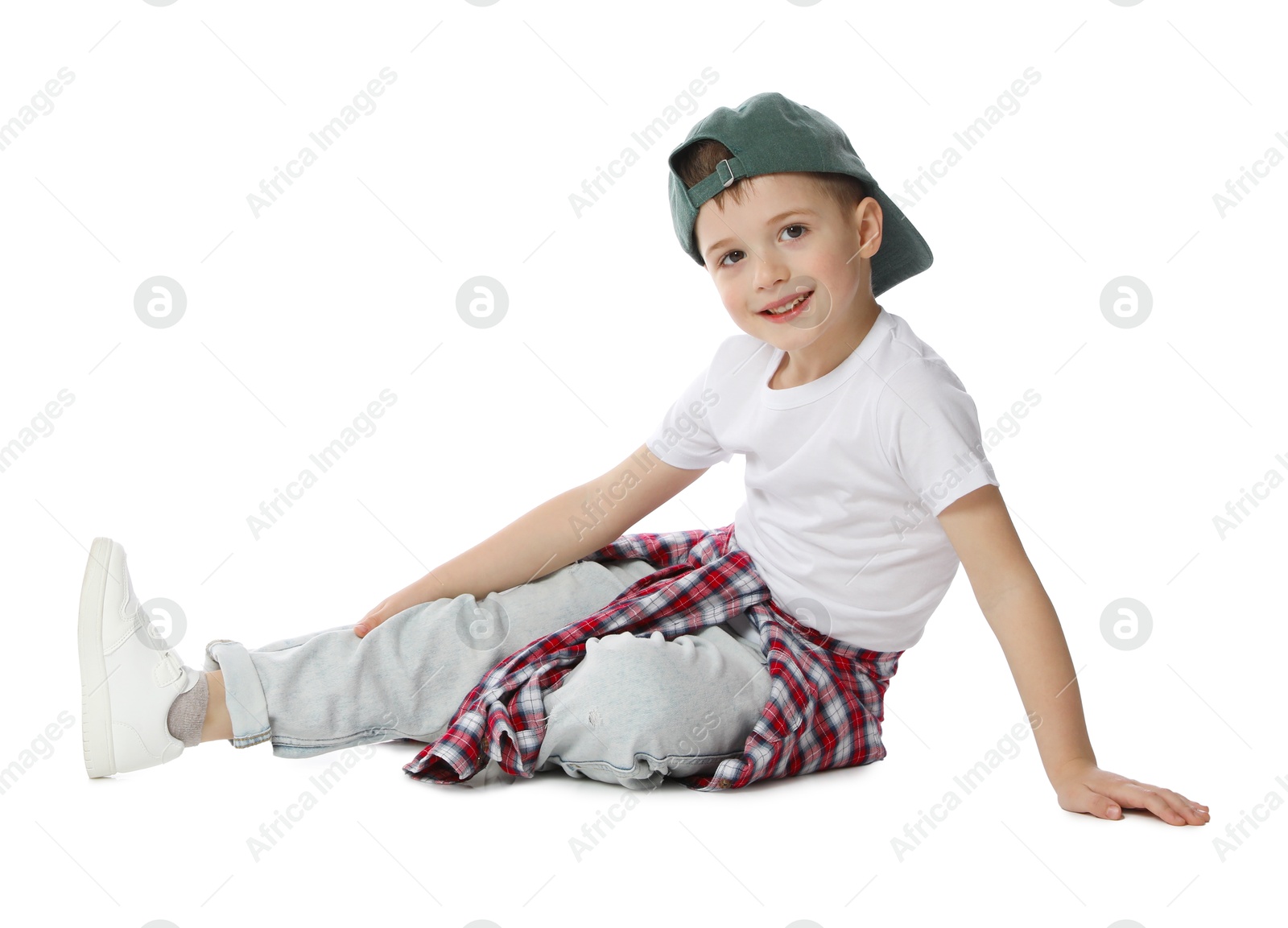 Happy little boy in baseball hat dancing on white background Photo of Happy little boy in baseball hat dancing on white background