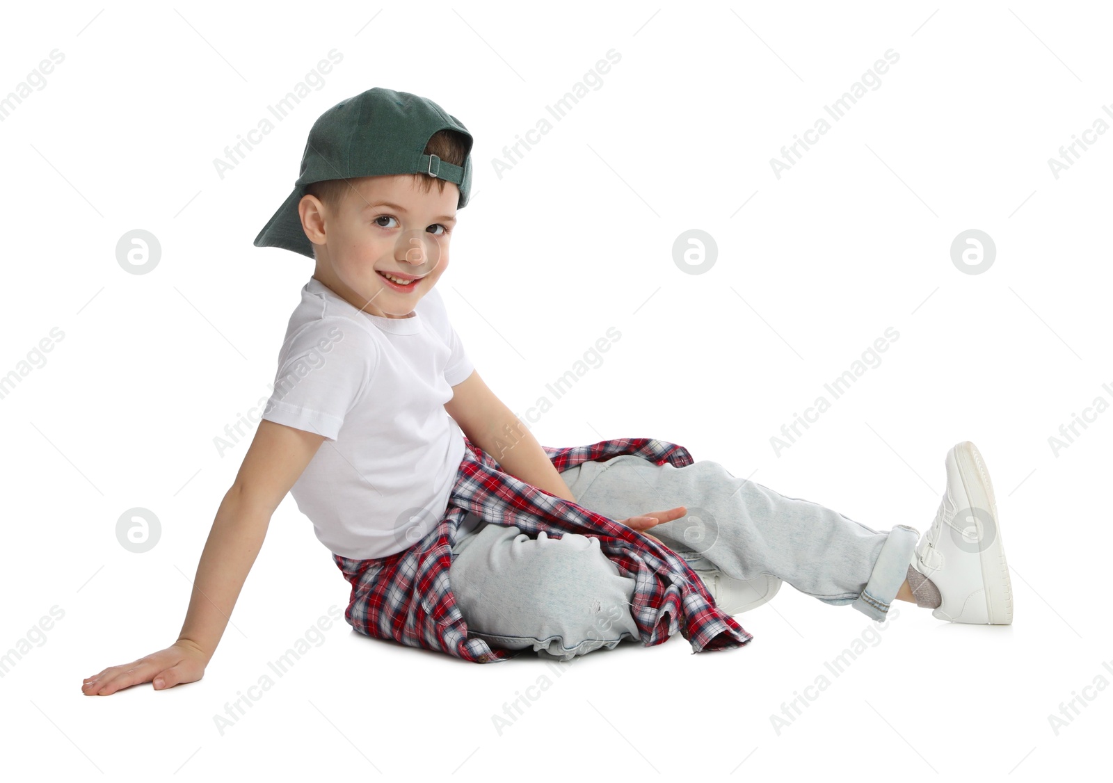 Happy little boy in baseball hat dancing on white background Photo of Happy little boy in baseball hat dancing on white background