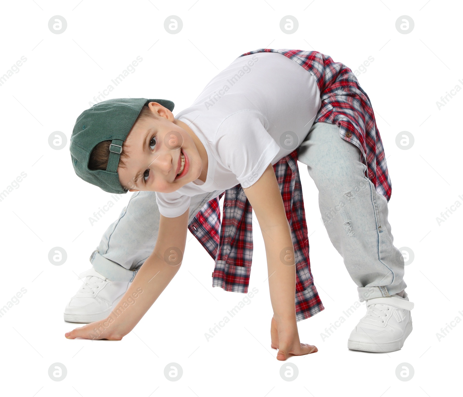 Happy little boy in baseball hat dancing on white background Photo of Happy little boy in baseball hat dancing on white background