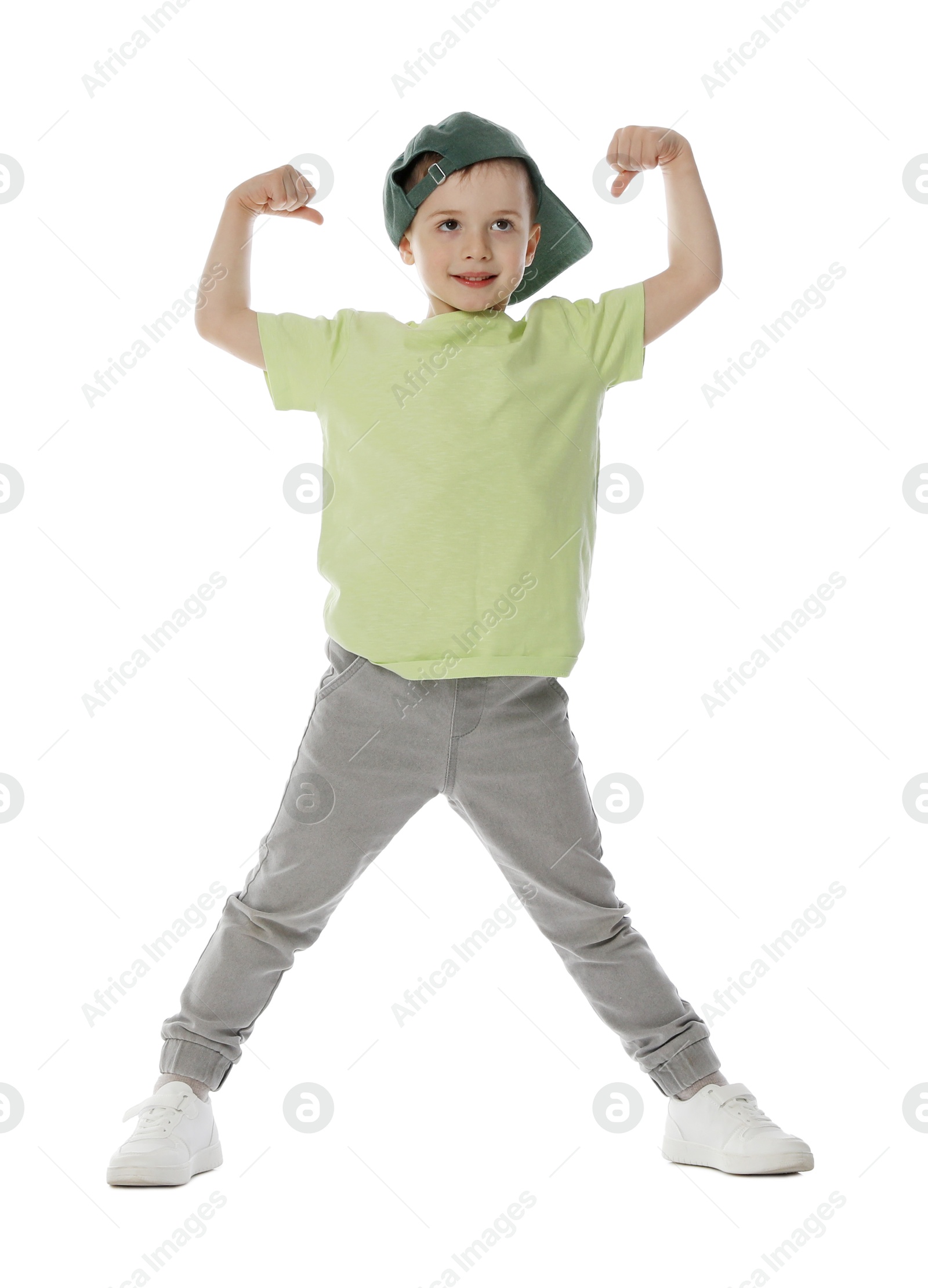 Happy little boy in baseball hat dancing on white background Photo of Happy little boy in baseball hat dancing on white background