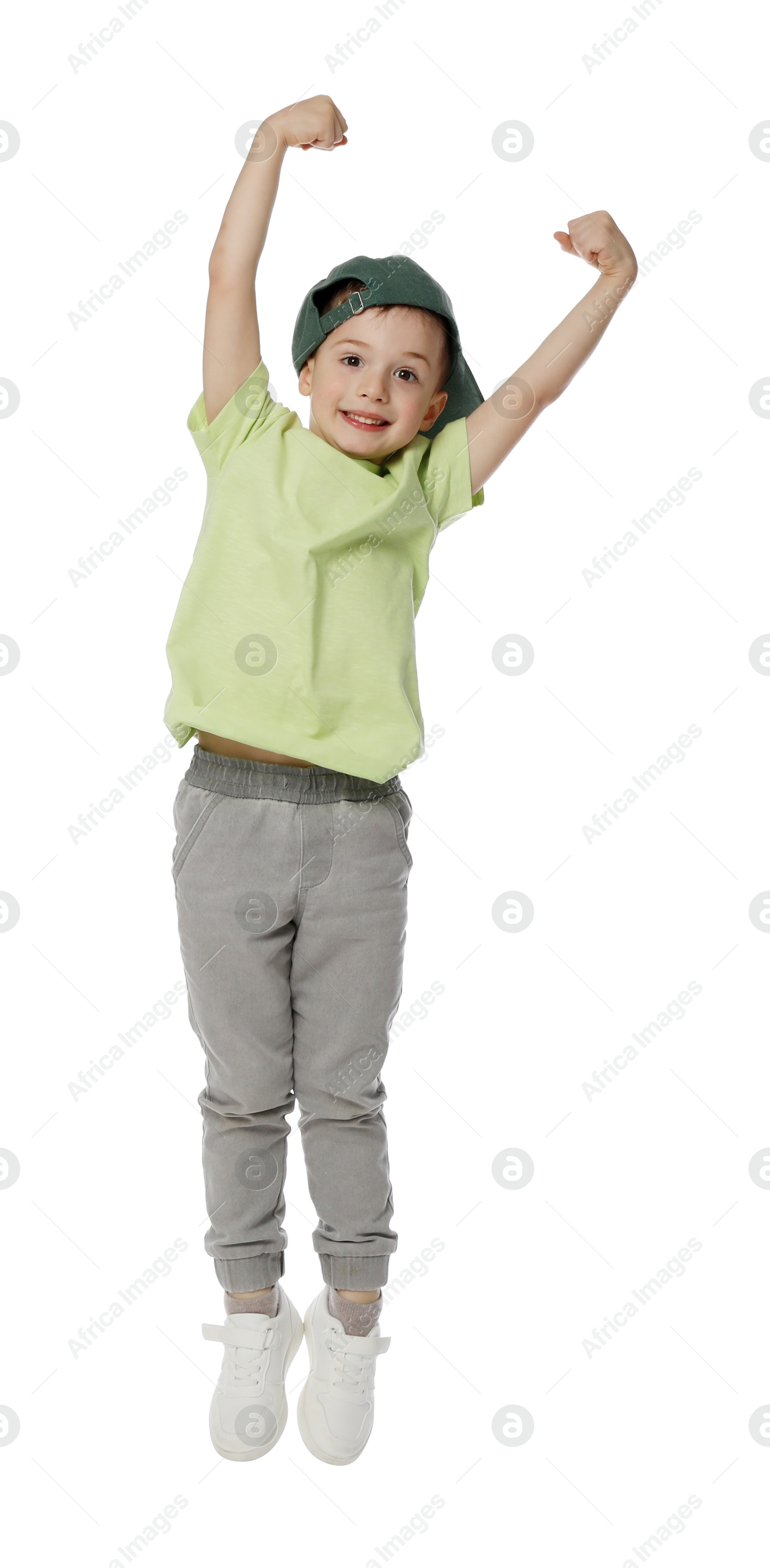 Happy little boy in baseball hat dancing on white background Photo of Happy little boy in baseball hat dancing on white background
