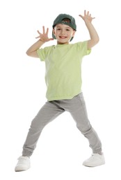 Photo of Happy little boy in baseball hat dancing on white background
