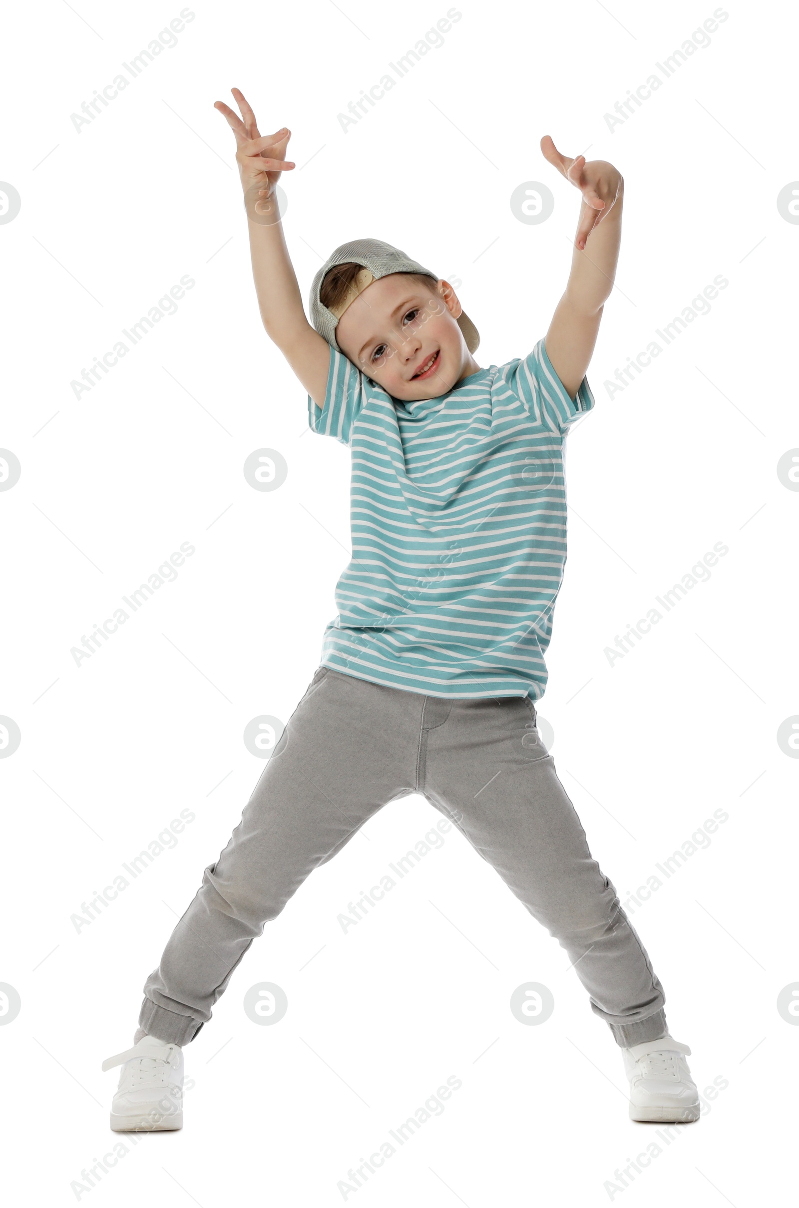 Happy little boy in baseball hat dancing on white background Photo of Happy little boy in baseball hat dancing on white background