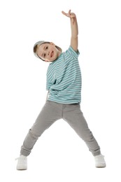 Photo of Happy little boy in baseball hat dancing on white background