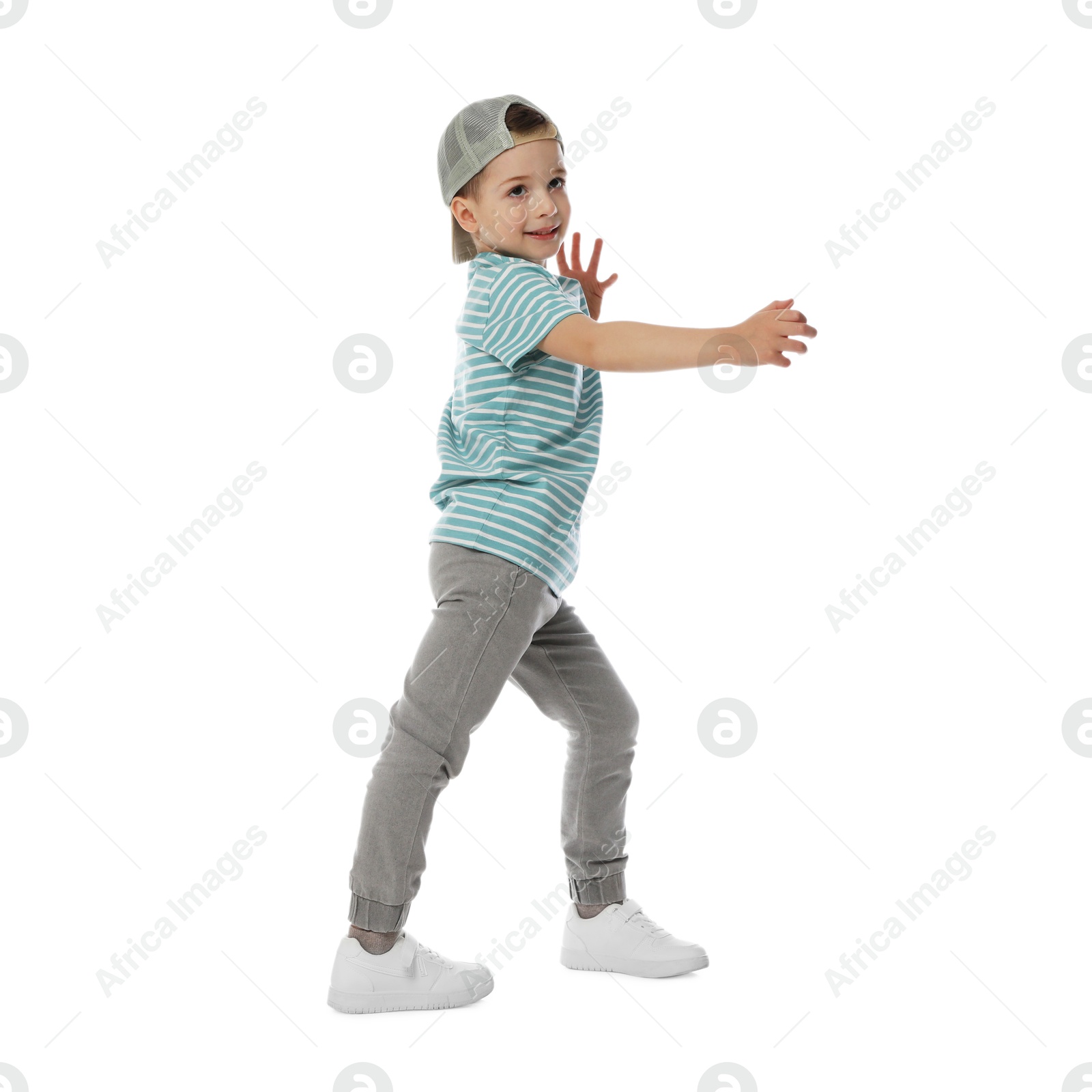 Happy little boy in baseball hat dancing on white background Photo of Happy little boy in baseball hat dancing on white background