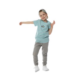 Photo of Happy little boy in baseball hat dancing on white background