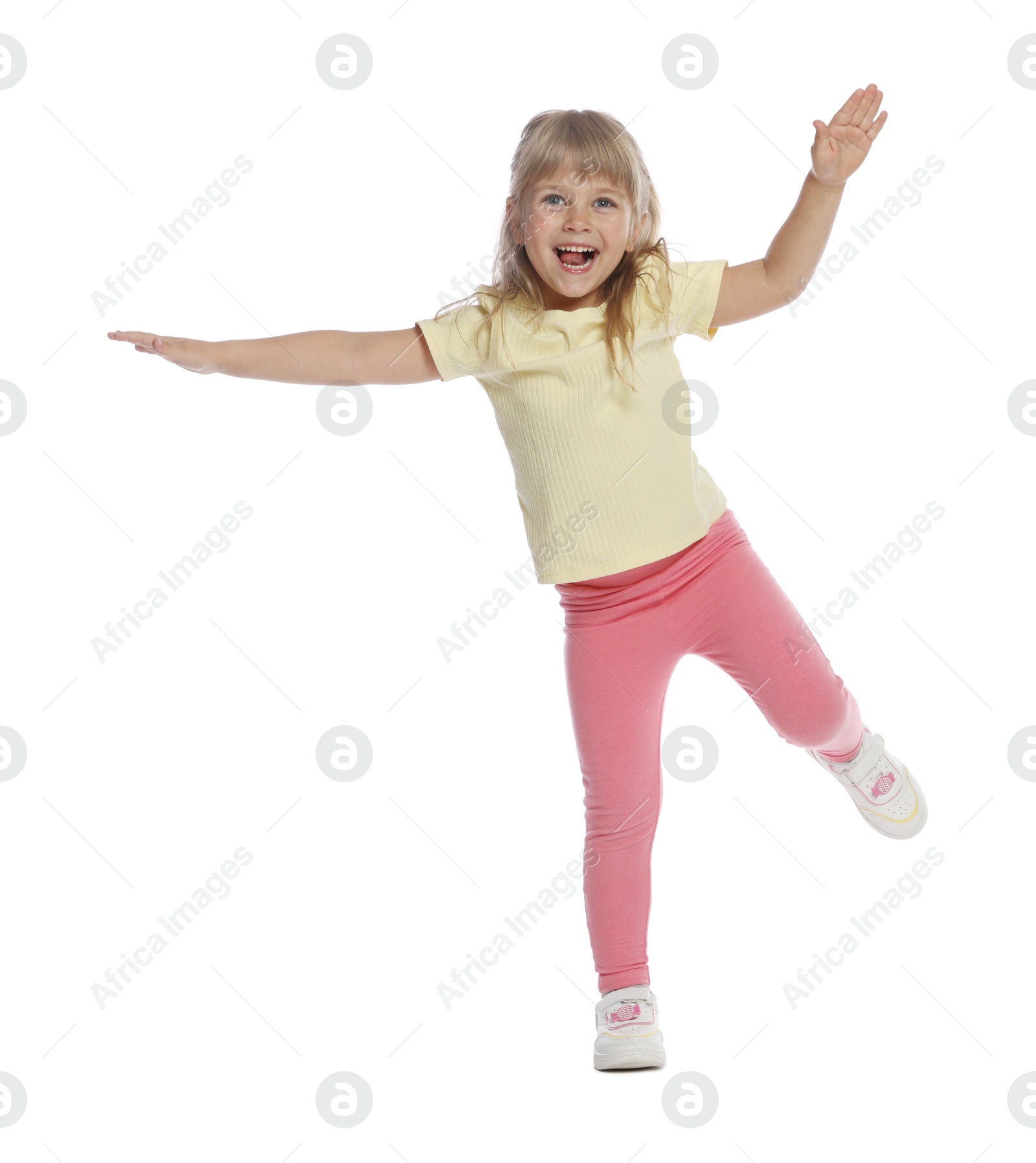 Happy little girl dancing on white background Photo of Happy little girl dancing on white background