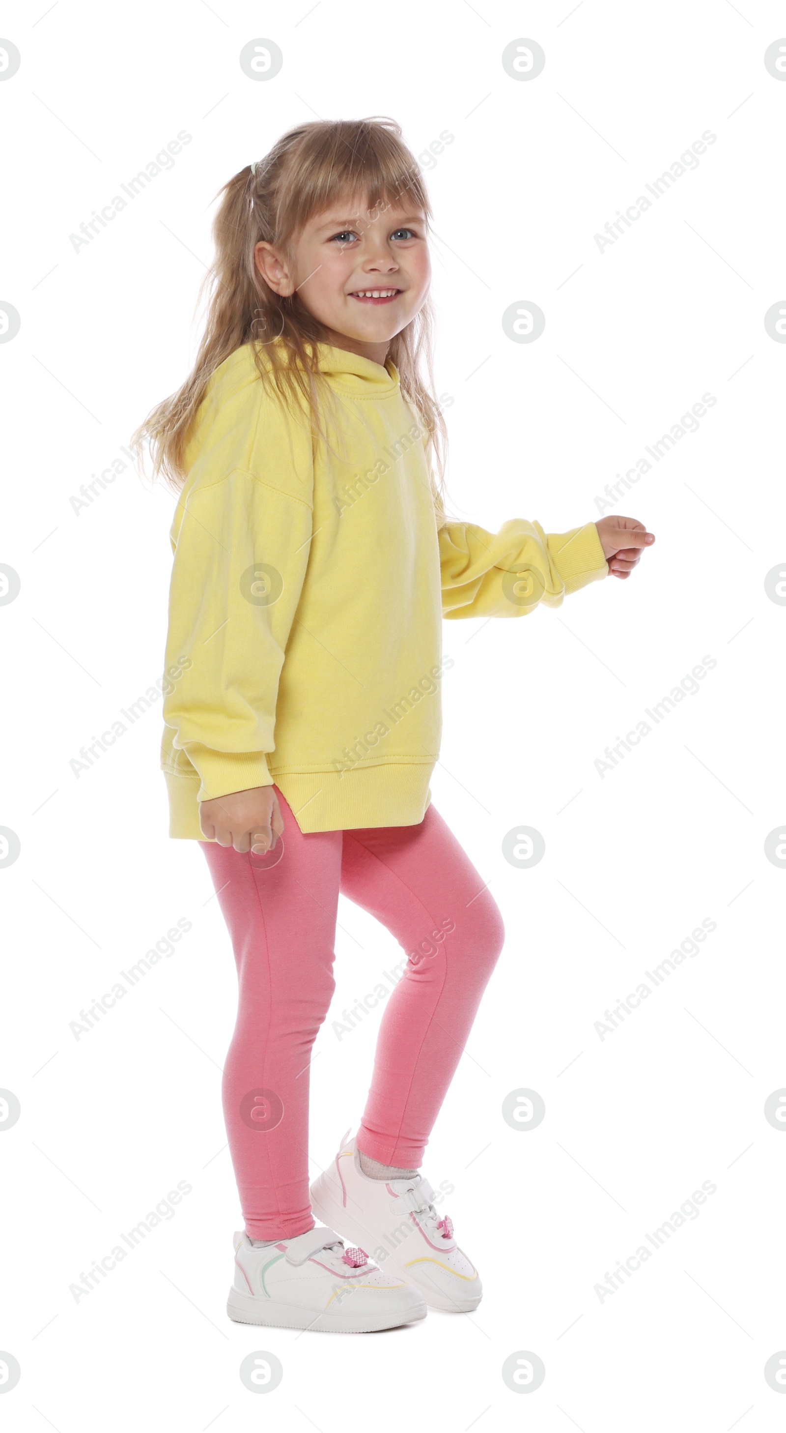 Happy little girl dancing on white background Photo of Happy little girl dancing on white background