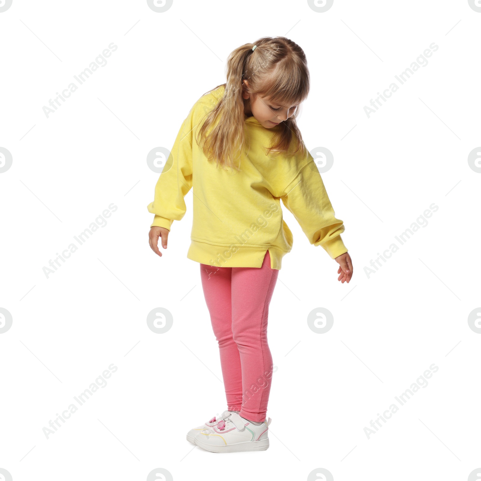 Cute little dancer standing on white background Photo of Cute little dancer standing on white background