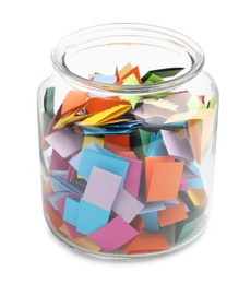 Photo of Colorful paper pieces in glass jar isolated on white