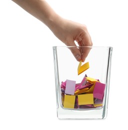 Photo of Woman taking color paper piece form glass holder on white background, closeup