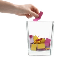 Photo of Woman taking color paper piece form glass holder on white background, closeup