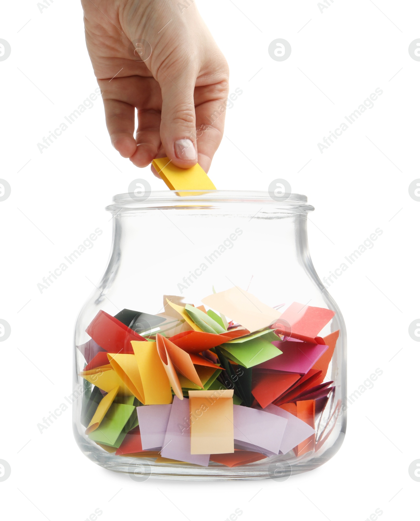 Woman taking color paper piece form glass jar on white background, closeup Photo of Woman taking color paper piece form glass jar on white background, closeup