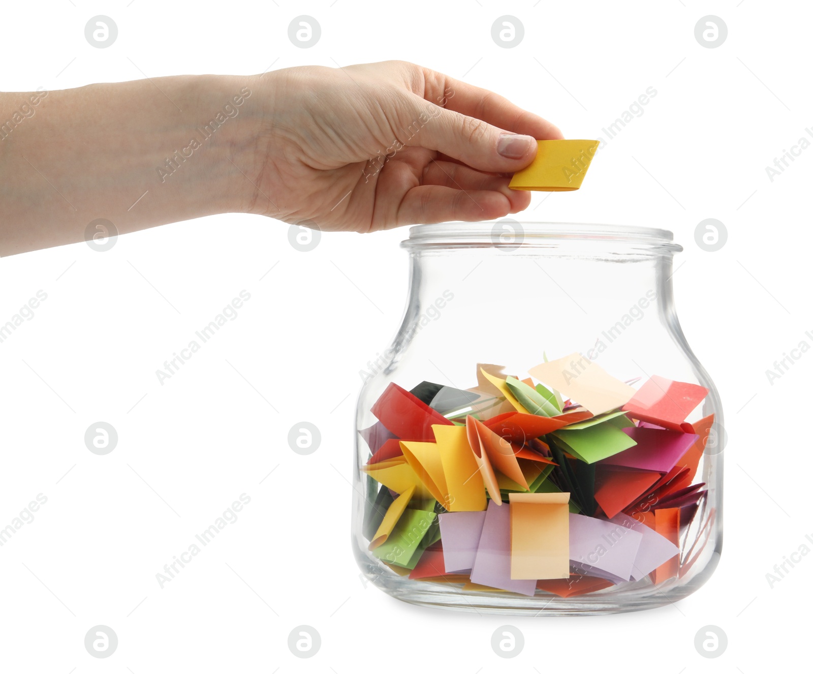 Woman taking color paper piece form glass jar on white background, closeup Photo of Woman taking color paper piece form glass jar on white background, closeup