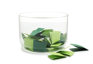 Photo of Colorful paper pieces in glass jar isolated on white