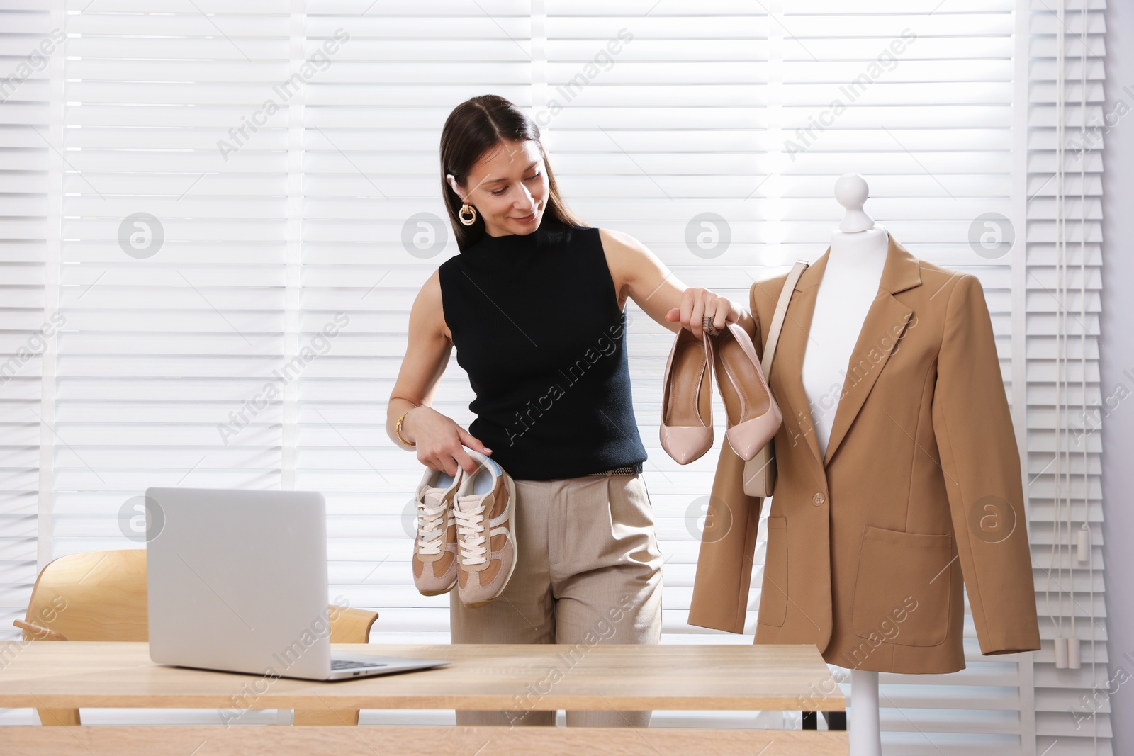 Professional stylist having online consultation with client via laptop indoors Photo of Professional stylist having online consultation with client via laptop indoors