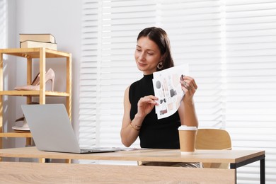 Photo of Professional stylist having online consultation with client via laptop at desk indoors