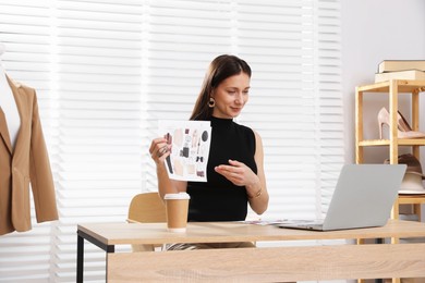 Photo of Professional stylist having online consultation with client via laptop at desk indoors