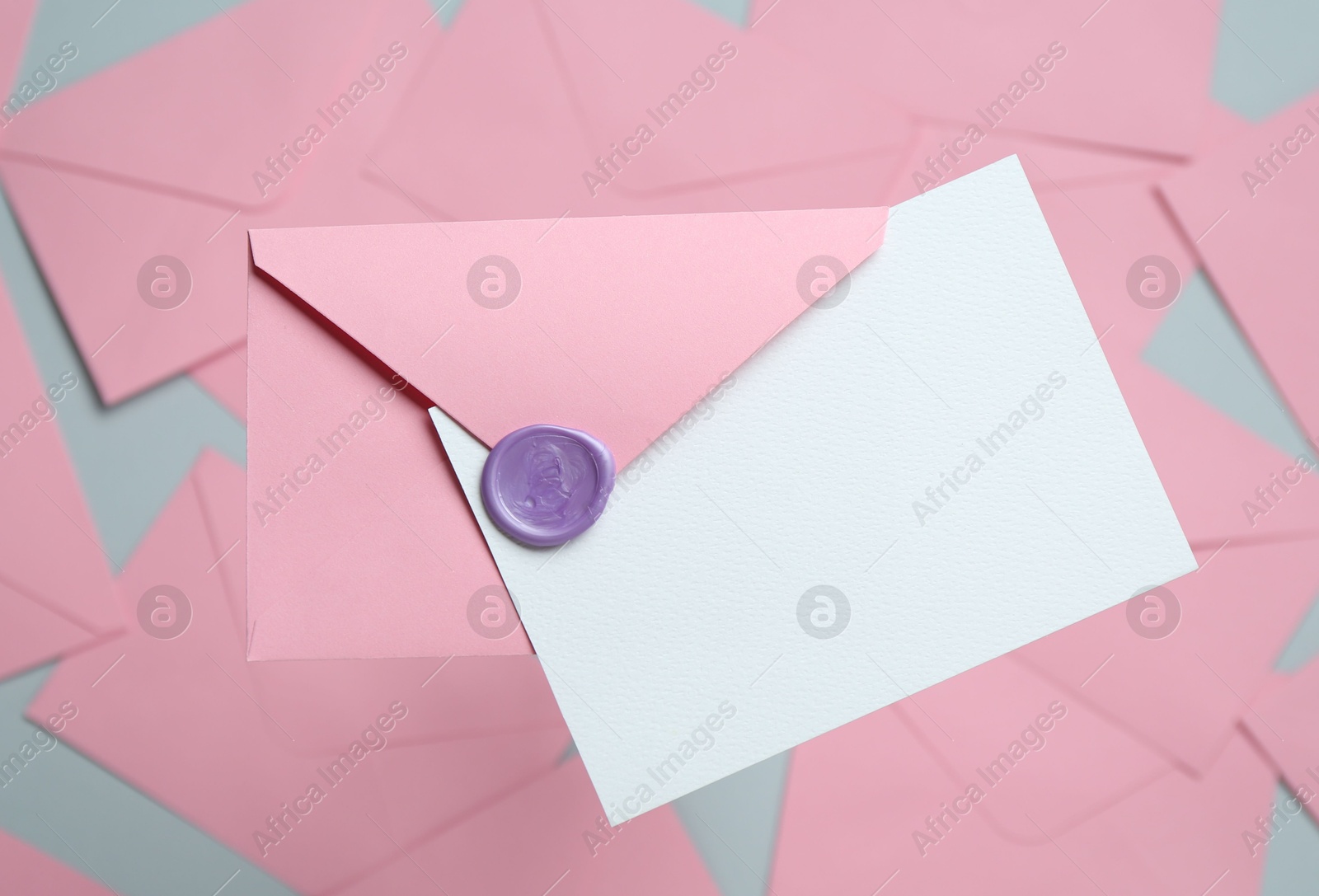 Blank invitation card and envelope on glass surface, top view. Space for design Photo of Blank invitation card and envelope on glass surface, top view. Space for design