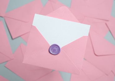 Photo of Blank invitation card and envelope on glass surface, top view. Space for design