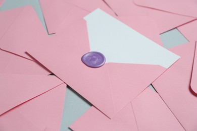 Photo of Blank invitation card and envelopes on grey background, closeup