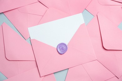 Photo of Blank invitation card and envelopes on grey background, flat lay. Space for design