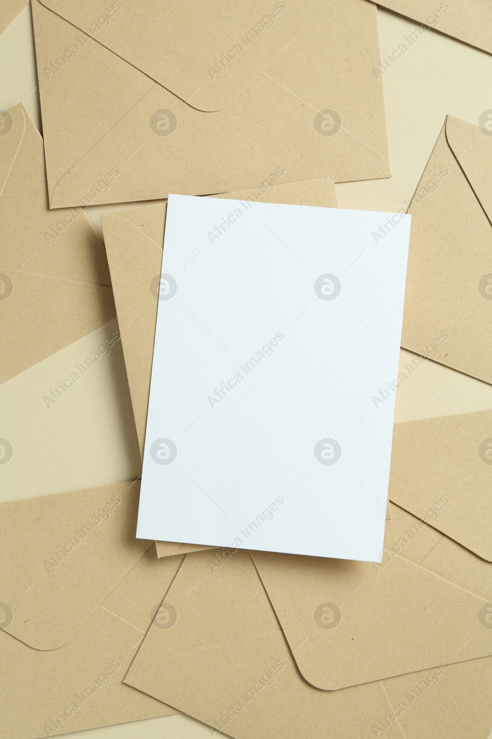 Blank invitation card and envelopes on beige background, flat lay. Space for design Photo of Blank invitation card and envelopes on beige background, flat lay. Space for design