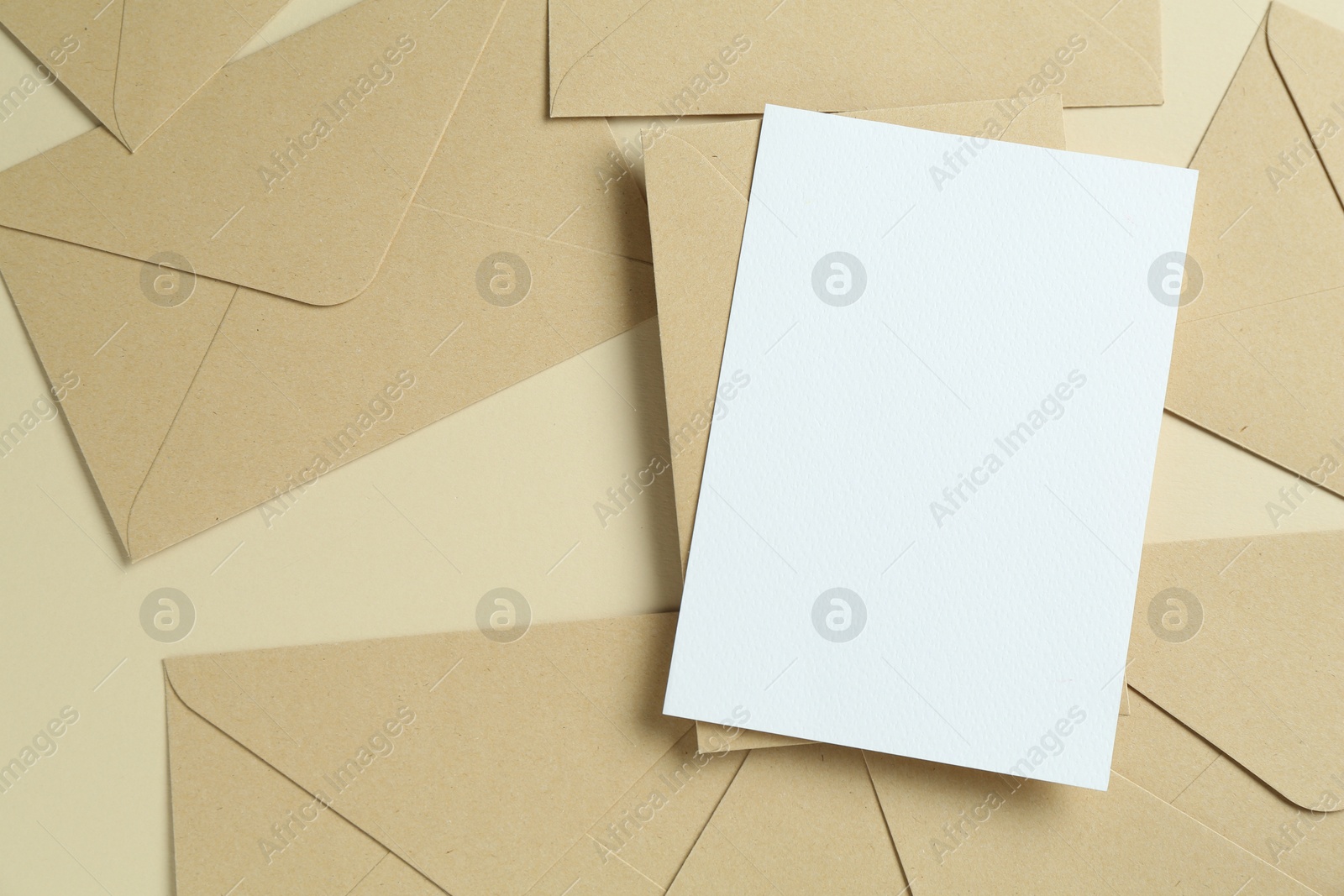 Blank invitation card and envelopes on beige background, flat lay. Space for design Photo of Blank invitation card and envelopes on beige background, flat lay. Space for design