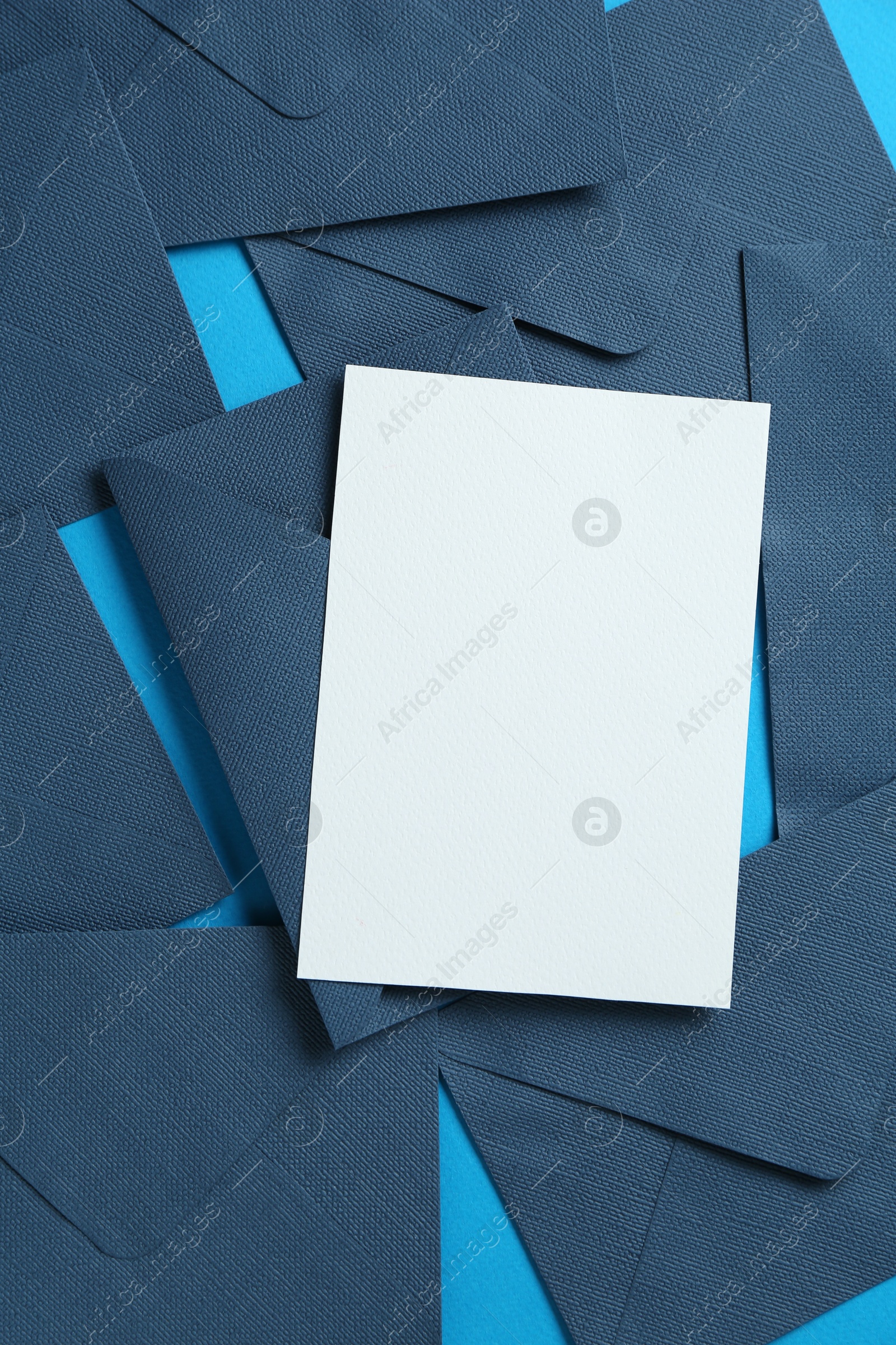 Blank invitation card and envelopes on light blue background, flat lay. Space for design Photo of Blank invitation card and envelopes on light blue background, flat lay. Space for design