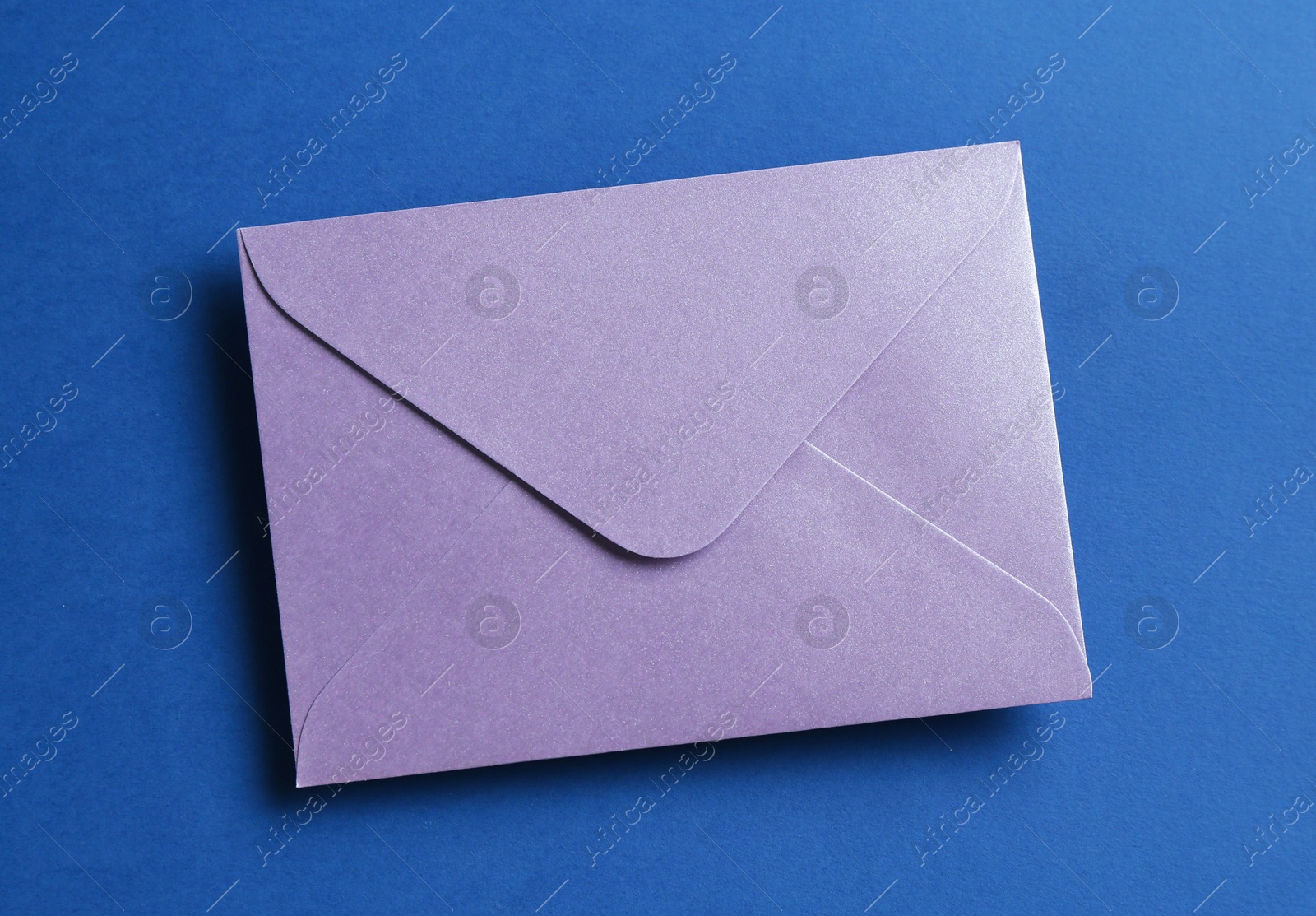 Beautiful invitation envelope on blue background, top view Photo of Beautiful invitation envelope on blue background, top view