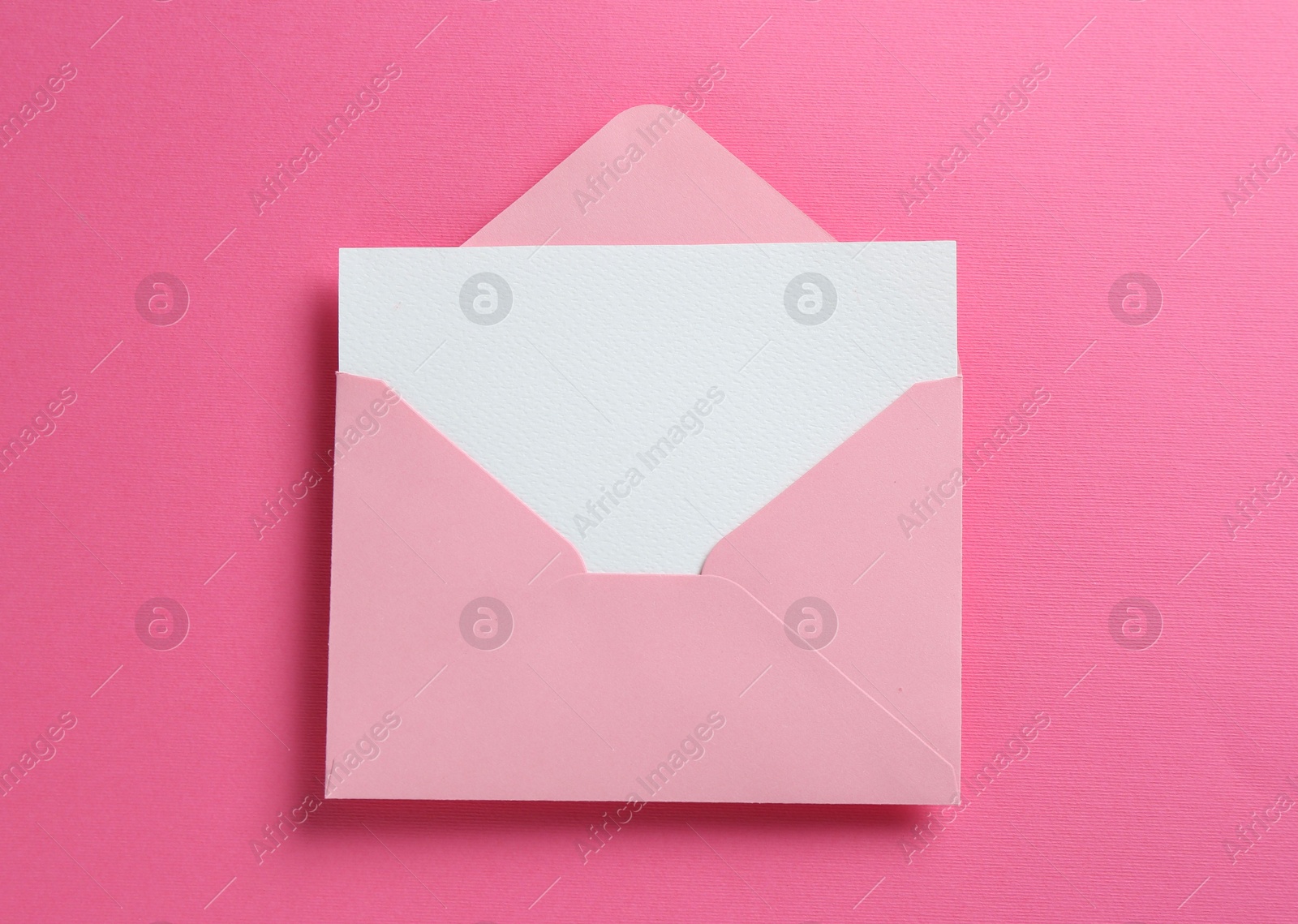 Blank invitation card and envelope on pink background, top view Photo of Blank invitation card and envelope on pink background, top view