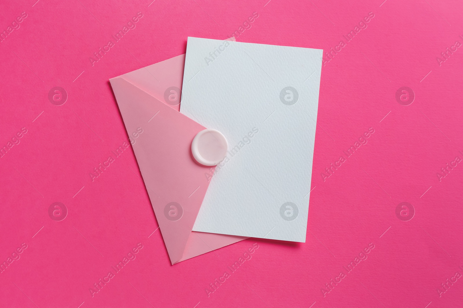 Blank invitation card and envelope on pink background, top view. Space for design Photo of Blank invitation card and envelope on pink background, top view. Space for design