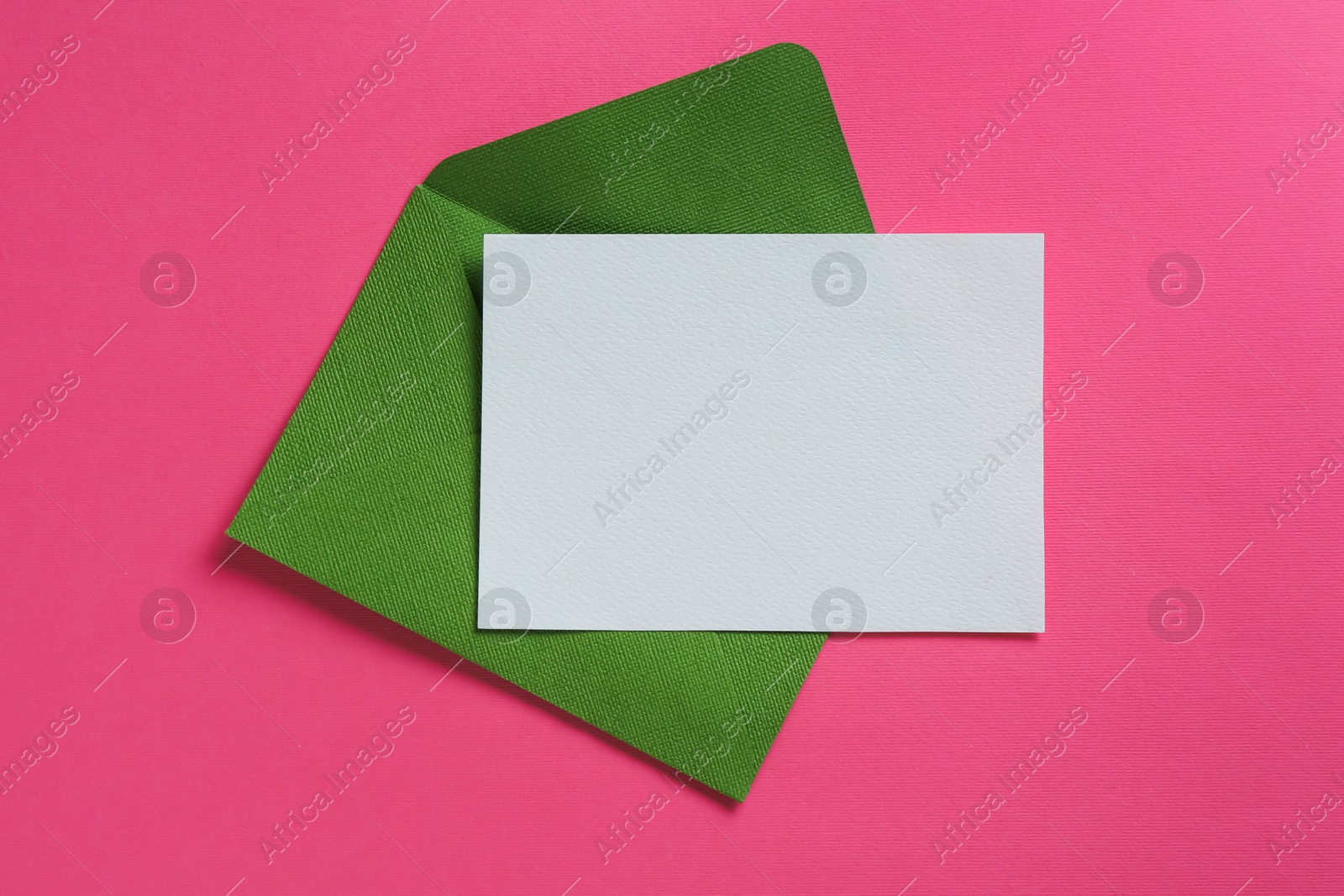 Blank invitation card and envelope on pink background, top view. Space for design Photo of Blank invitation card and envelope on pink background, top view. Space for design