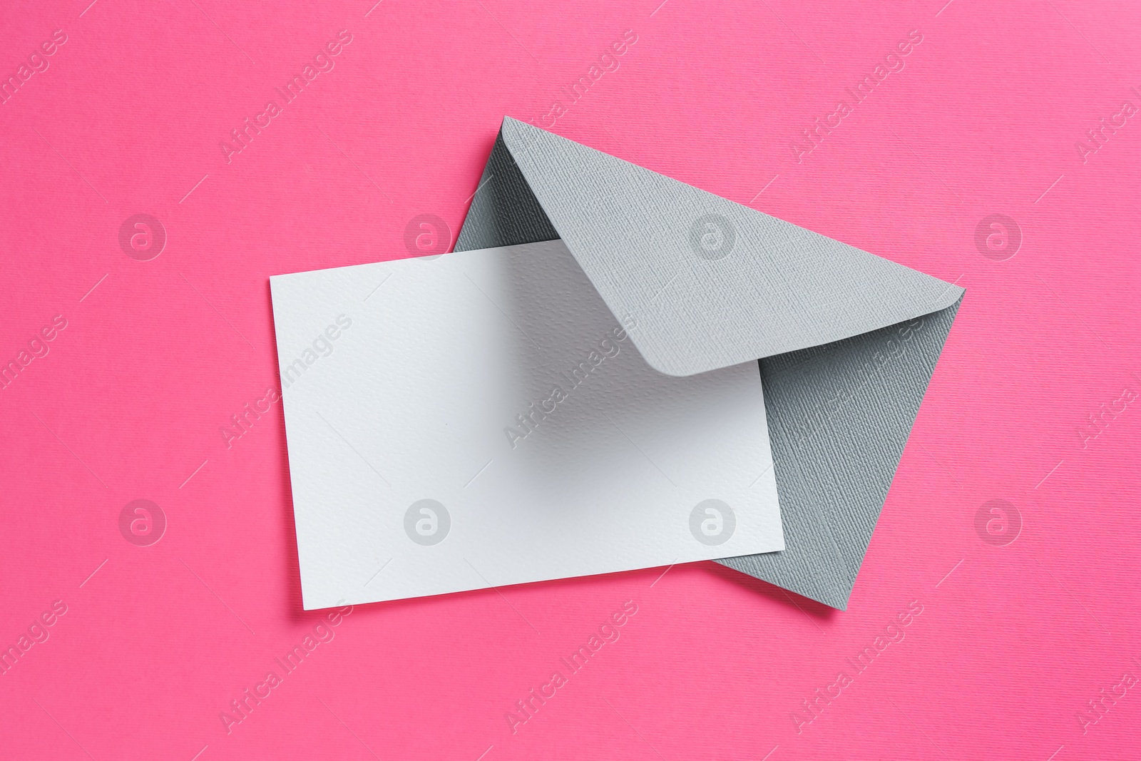 Blank invitation card and envelope on pink background, top view. Space for design Photo of Blank invitation card and envelope on pink background, top view. Space for design