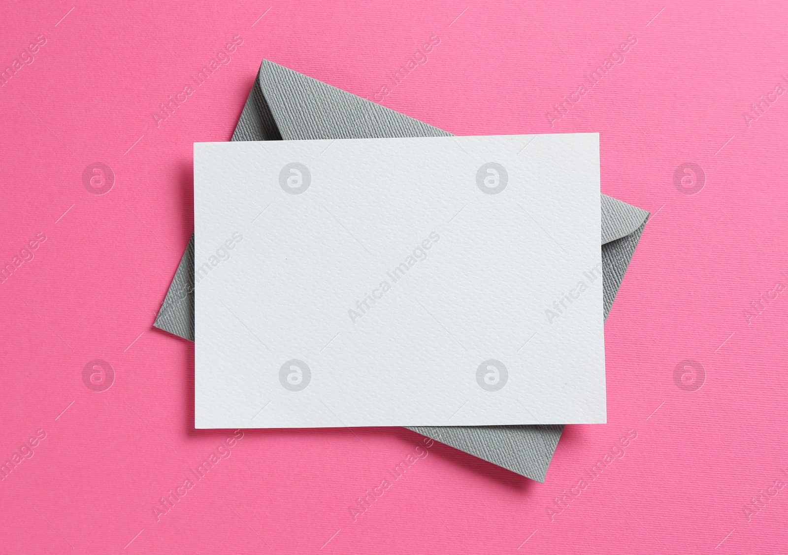 Blank invitation card and envelope on pink background, top view. Space for design Photo of Blank invitation card and envelope on pink background, top view. Space for design