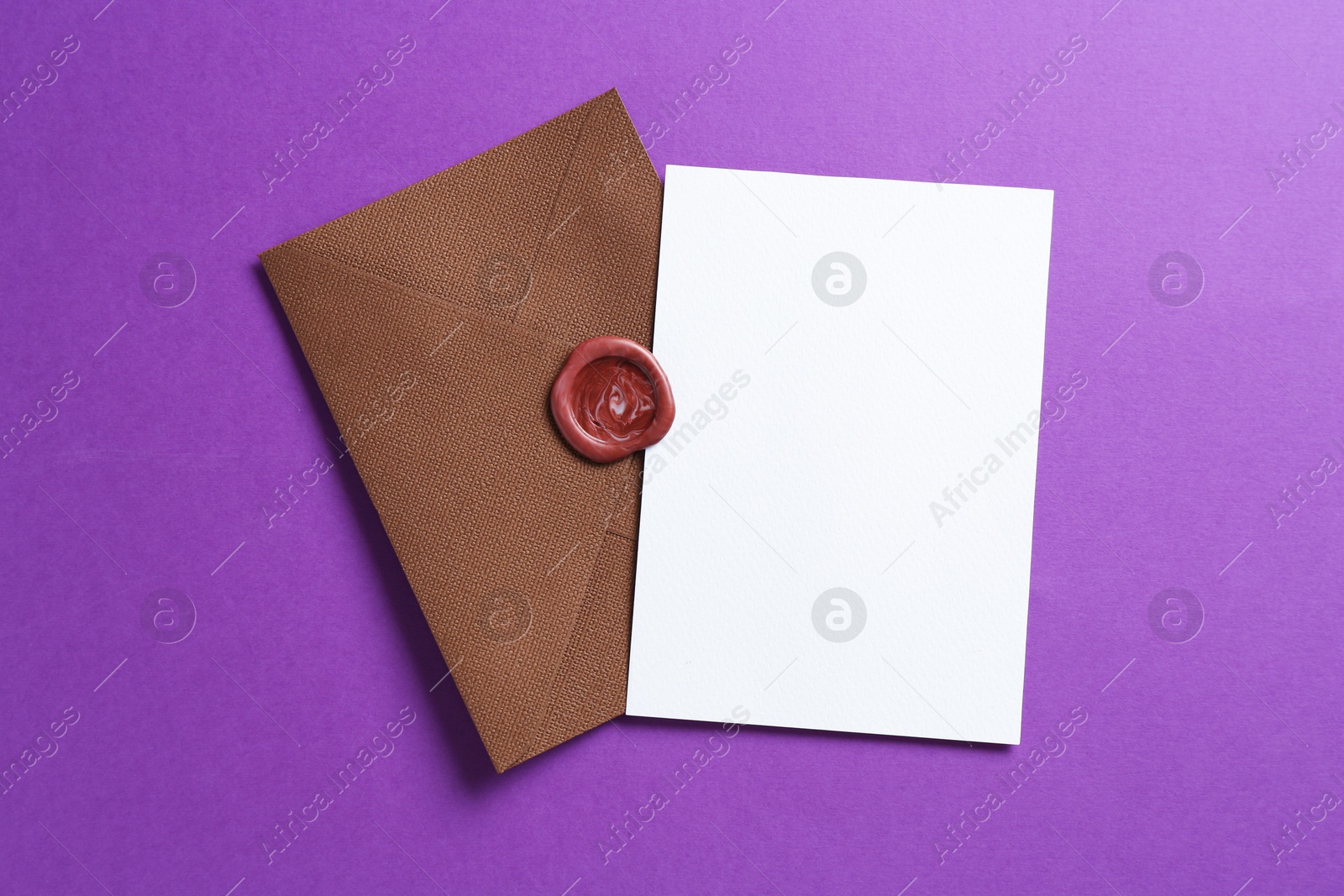 Blank invitation card and envelope on purple background, top view. Space for design Photo of Blank invitation card and envelope on purple background, top view. Space for design
