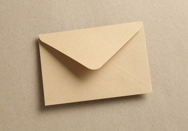 Photo of Beautiful invitation envelope on carton, top view