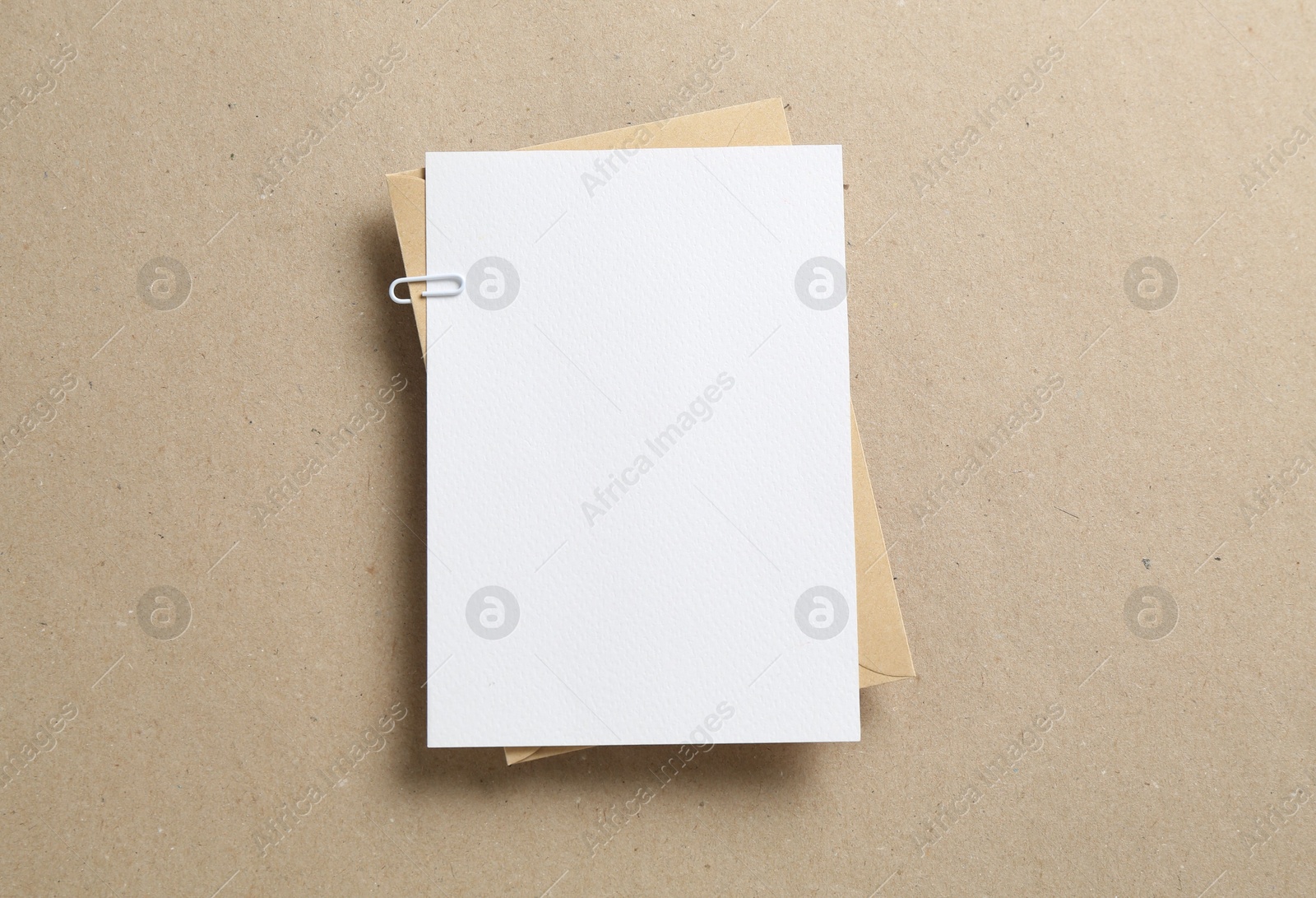 Blank invitation card and envelope on carton, top view. Space for design Photo of Blank invitation card and envelope on carton, top view. Space for design