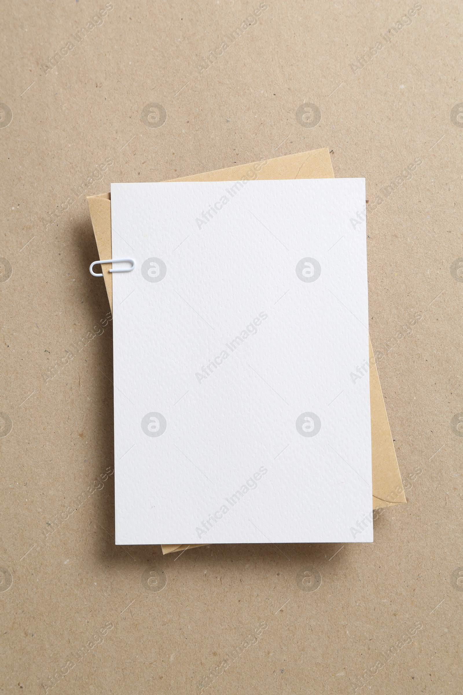 Blank invitation card and envelope on carton, top view. Space for design Photo of Blank invitation card and envelope on carton, top view. Space for design
