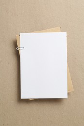 Photo of Blank invitation card and envelope on carton, top view. Space for design