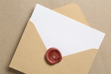 Photo of Blank invitation card and envelope on carton, top view. Space for design