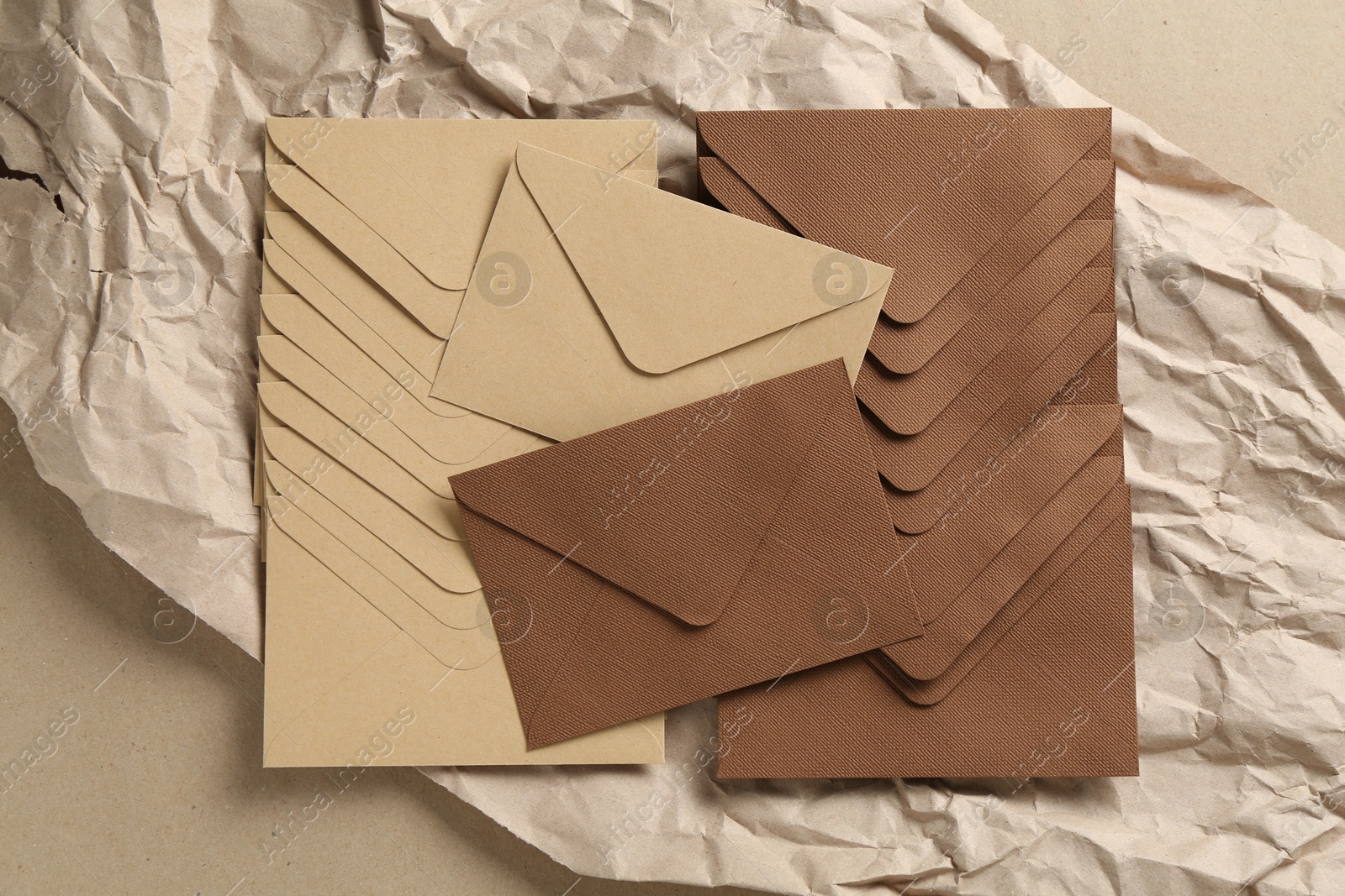 Beautiful invitation envelopes and parchment paper on carton, top view Photo of Beautiful invitation envelopes and parchment paper on carton, top view