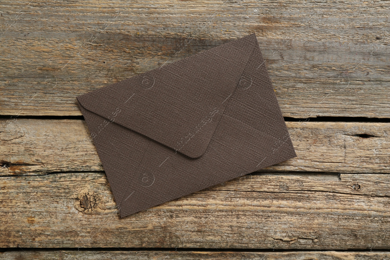 Beautiful invitation envelope on wooden table, top view Photo of Beautiful invitation envelope on wooden table, top view