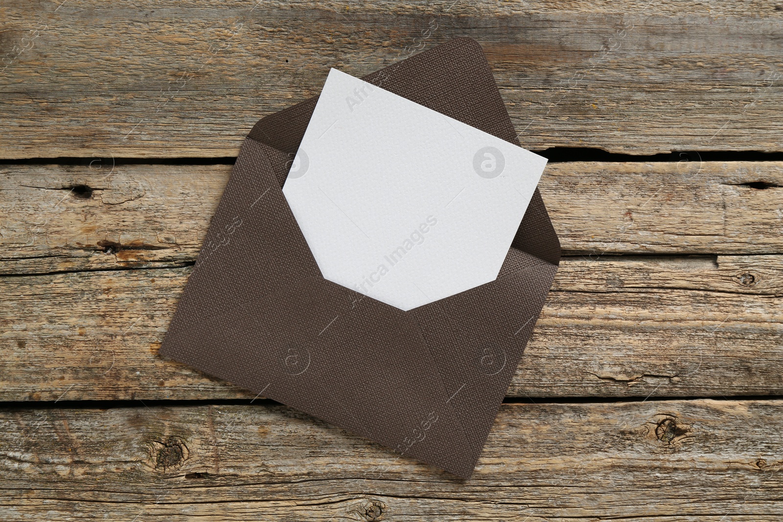 Blank invitation card and envelope on wooden table, top view. Space for design Photo of Blank invitation card and envelope on wooden table, top view. Space for design