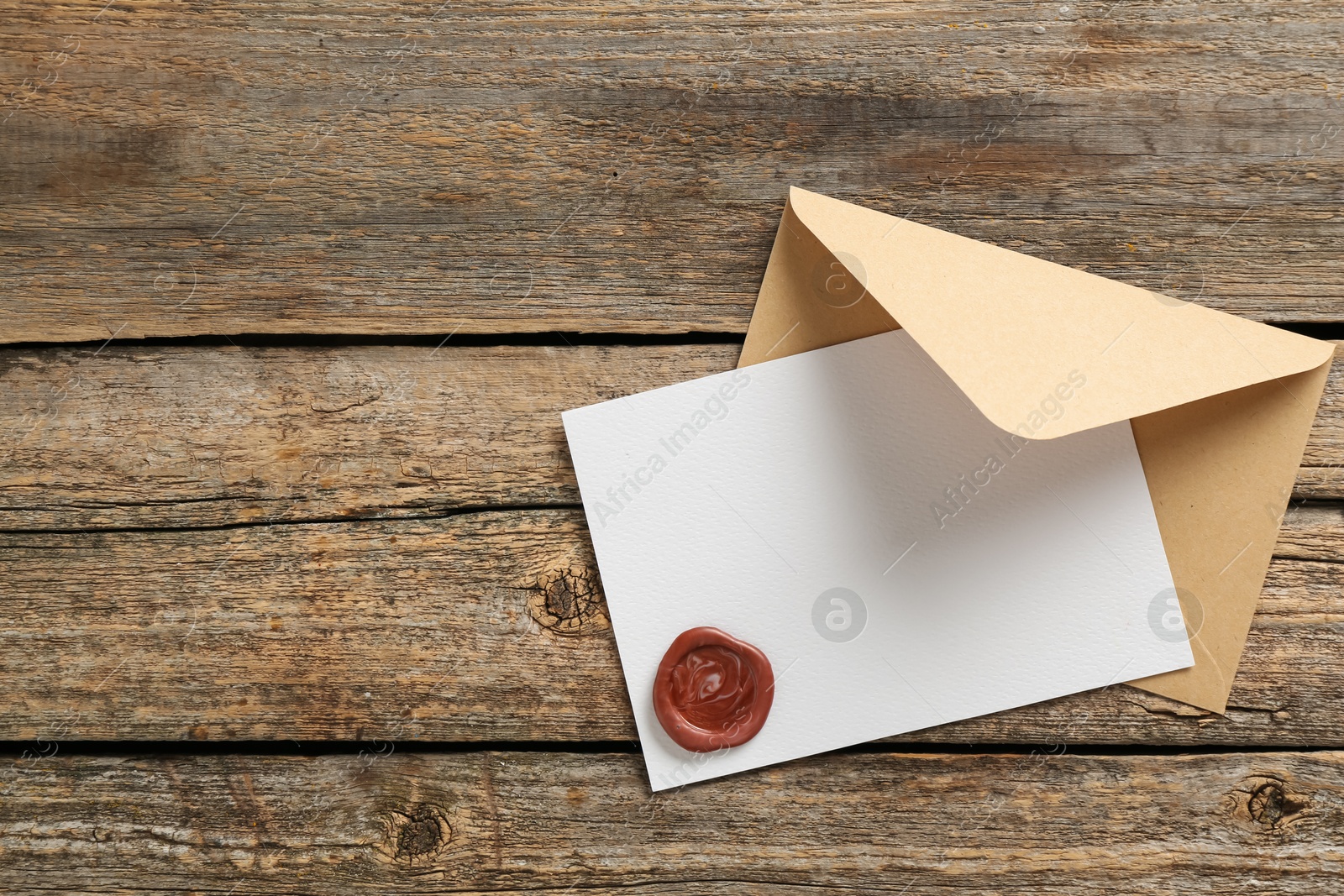 Blank invitation card with wax seal and envelope on wooden table, top view. Space for design Photo of Blank invitation card with wax seal and envelope on wooden table, top view. Space for design