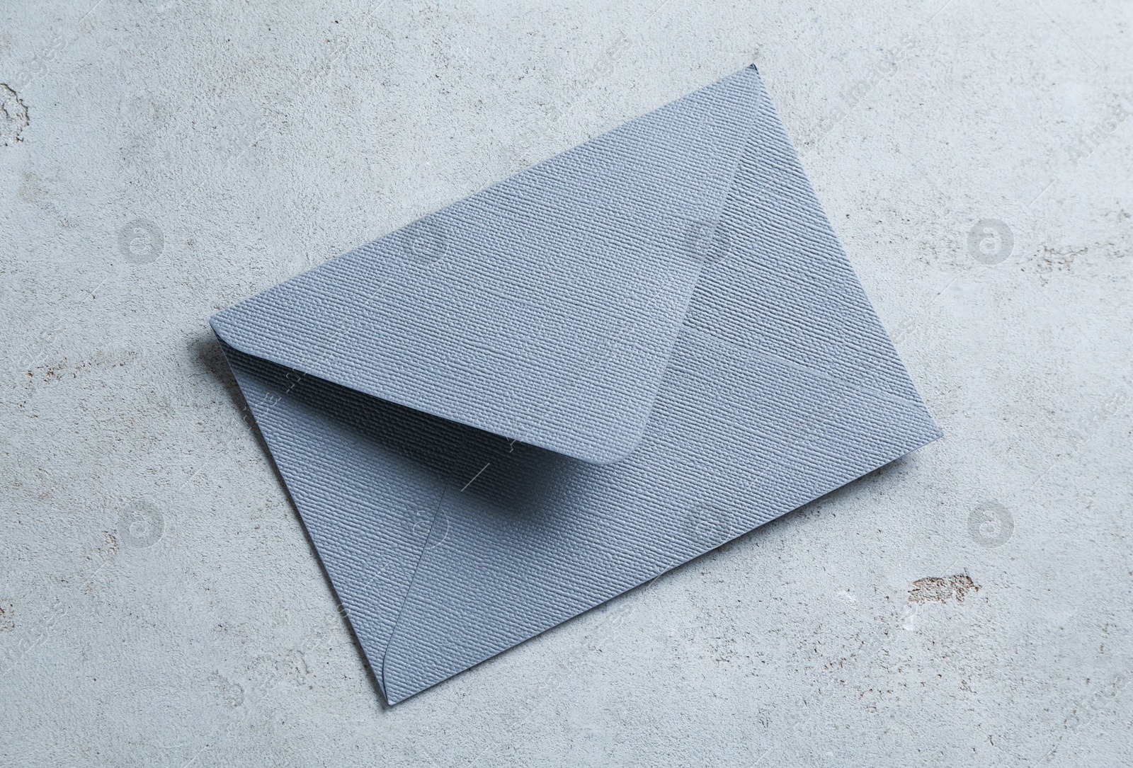Beautiful invitation envelope on light grey table, top view Photo of Beautiful invitation envelope on light grey table, top view