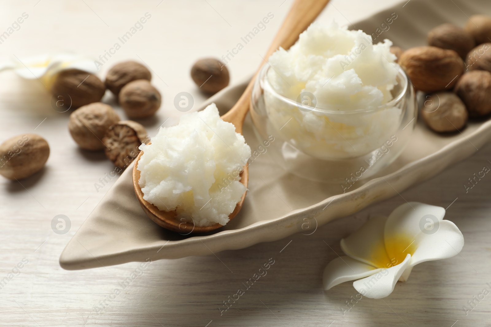 Natural shea butter on white wooden table, closeup Photo of Natural shea butter on white wooden table, closeup