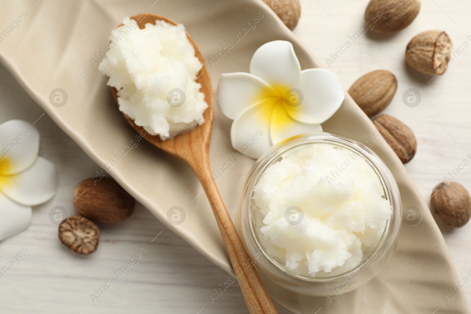 Natural shea butter on white wooden table, flat lay Photo of Natural shea butter on white wooden table, flat lay