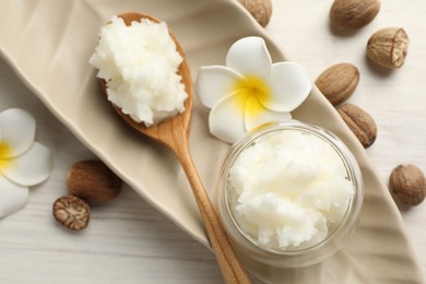 Photo of Natural shea butter on white wooden table, flat lay