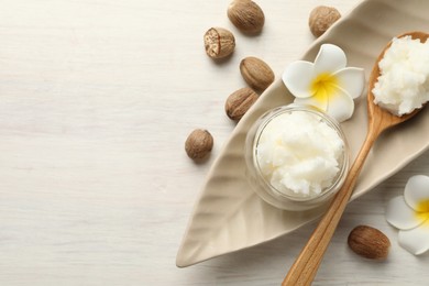 Photo of Natural shea butter on white wooden table, flat lay. Space for text